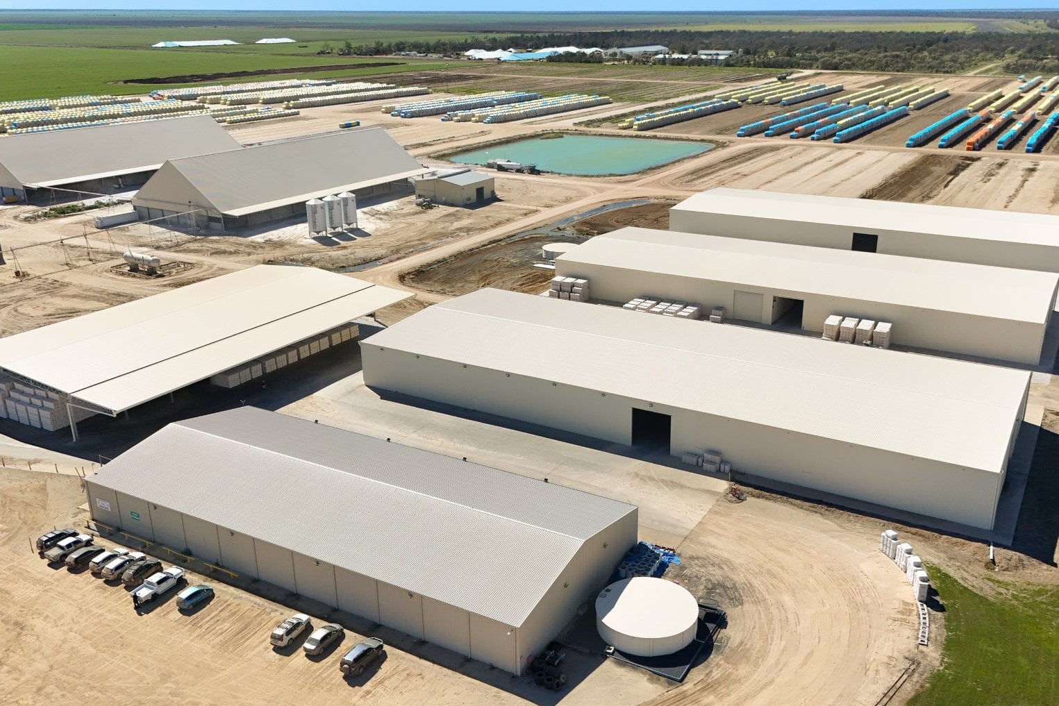 Aerial view of the P&J Harris & Sons Collymongle gin site with cotton bale storage sheds and cottonseed sheds near Collarenebri, NSW, built by Entegra